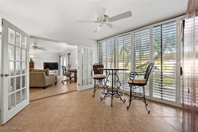 office space with french doors, ceiling fan, light tile patterned floors, and a wealth of natural light