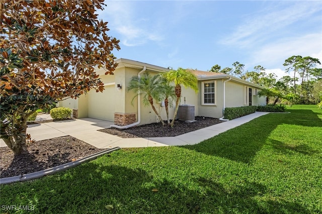 exterior space with a front yard and central AC