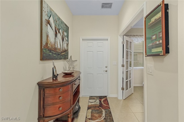 hall with light tile patterned floors