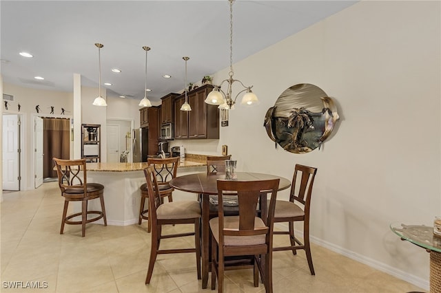 dining room featuring a chandelier and light tile patterned floors