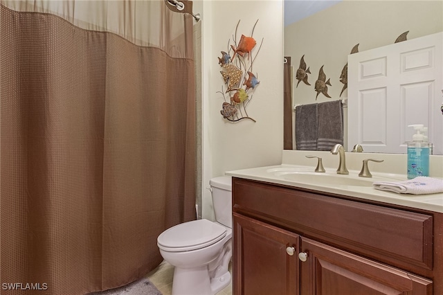 bathroom with vanity, a shower with curtain, toilet, and tile patterned floors