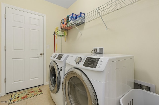 washroom with separate washer and dryer and light tile patterned floors