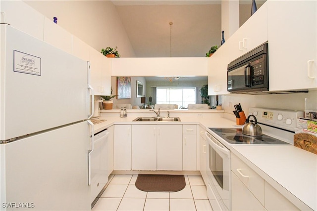 kitchen featuring white cabinetry, sink, light tile patterned floors, and white appliances