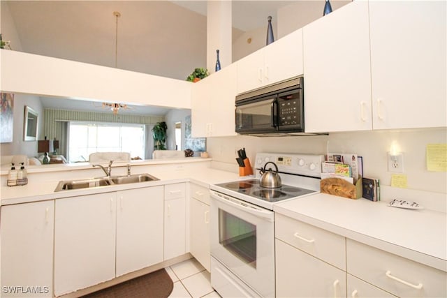 kitchen with white cabinetry, sink, light tile patterned floors, and white electric stove