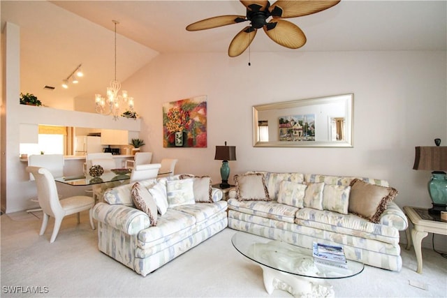 carpeted living room featuring ceiling fan with notable chandelier and vaulted ceiling