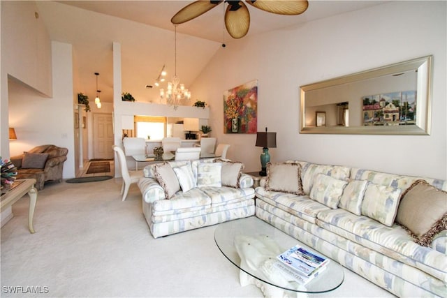 carpeted living room featuring ceiling fan with notable chandelier and high vaulted ceiling