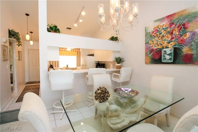 tiled dining room featuring a towering ceiling and an inviting chandelier