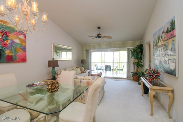 dining area with ceiling fan with notable chandelier, light carpet, and vaulted ceiling