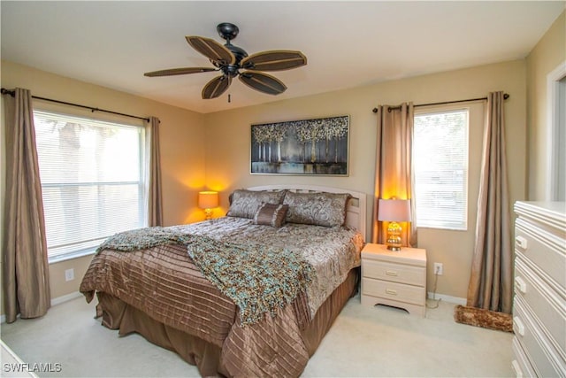 bedroom featuring ceiling fan and light carpet