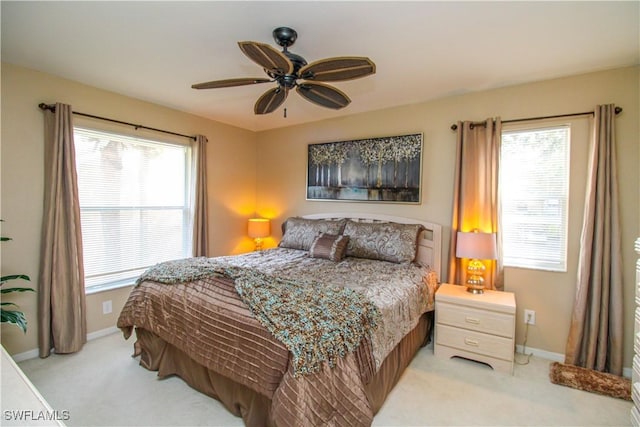 bedroom featuring ceiling fan and light colored carpet