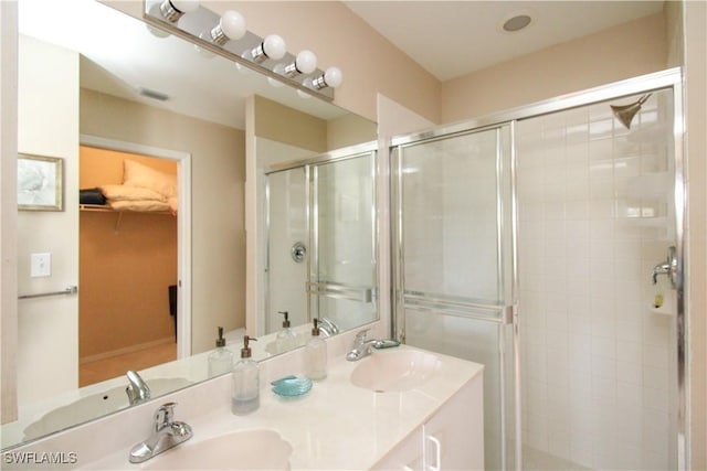 bathroom with a shower with door and vanity