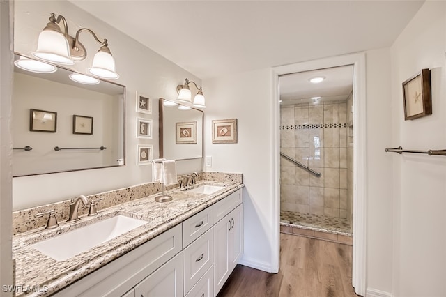 bathroom with vanity, hardwood / wood-style floors, and a shower with shower door