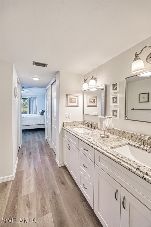 bathroom with vanity and hardwood / wood-style floors