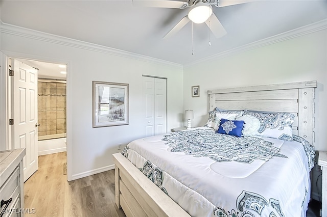 bedroom featuring ensuite bathroom, light wood-type flooring, a closet, ceiling fan, and ornamental molding