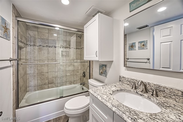 full bathroom featuring vanity, toilet, hardwood / wood-style flooring, and enclosed tub / shower combo