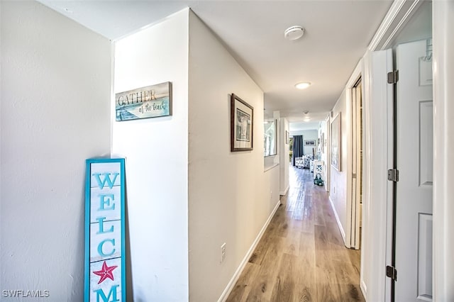 hallway with light hardwood / wood-style floors