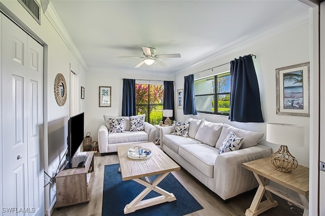 living room with crown molding, hardwood / wood-style flooring, and ceiling fan