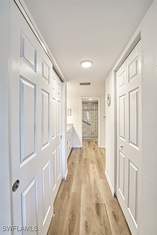 corridor featuring light wood-type flooring