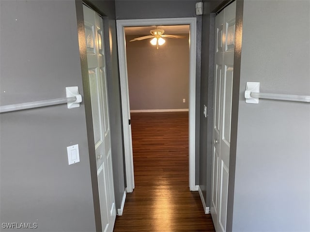 hallway with dark hardwood / wood-style flooring