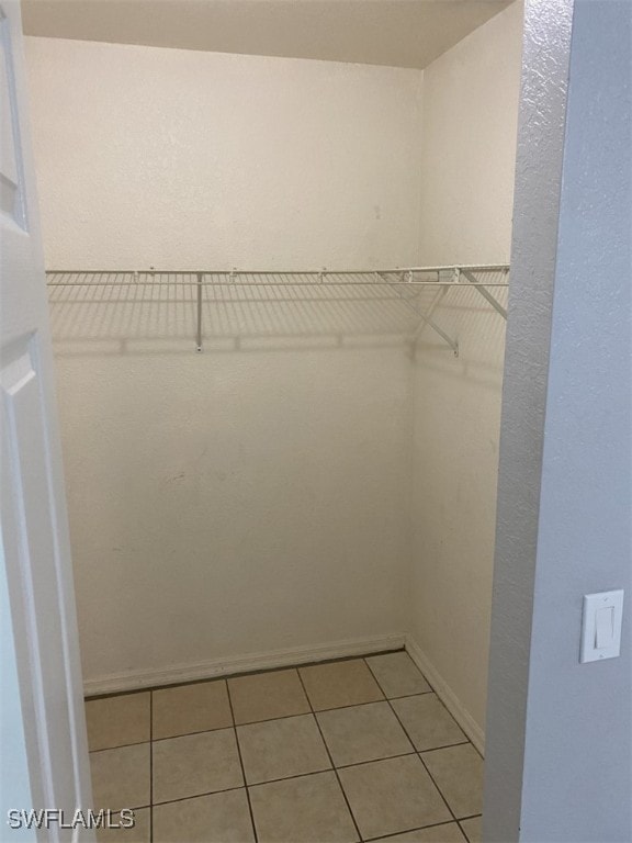 spacious closet with light tile patterned flooring