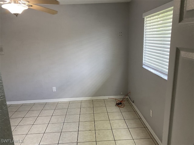 tiled empty room featuring ceiling fan