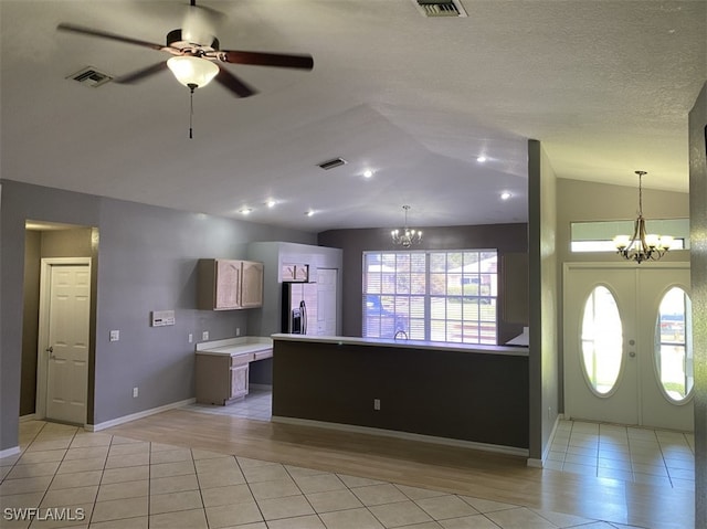 kitchen featuring lofted ceiling, stainless steel fridge with ice dispenser, light hardwood / wood-style flooring, ceiling fan with notable chandelier, and french doors