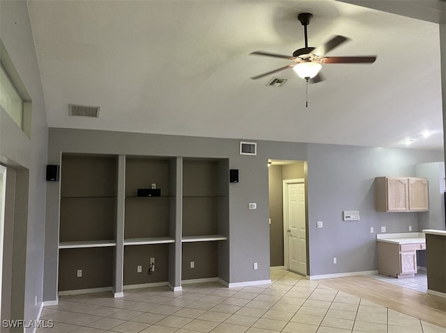 tiled spare room with ceiling fan and built in features