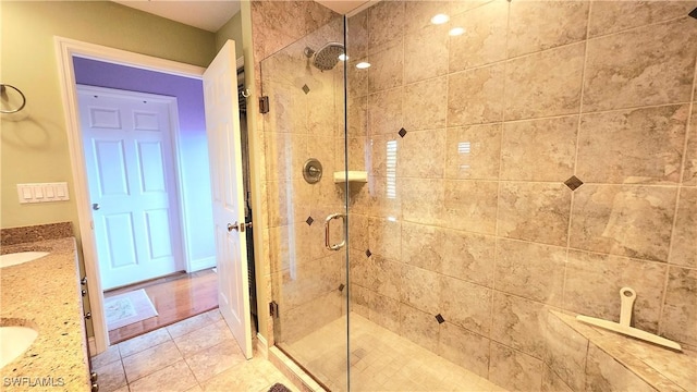 bathroom featuring vanity and a shower with door