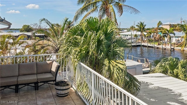 balcony with a water view and an outdoor living space