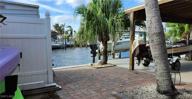 exterior space featuring a water view, a boat dock, and grilling area