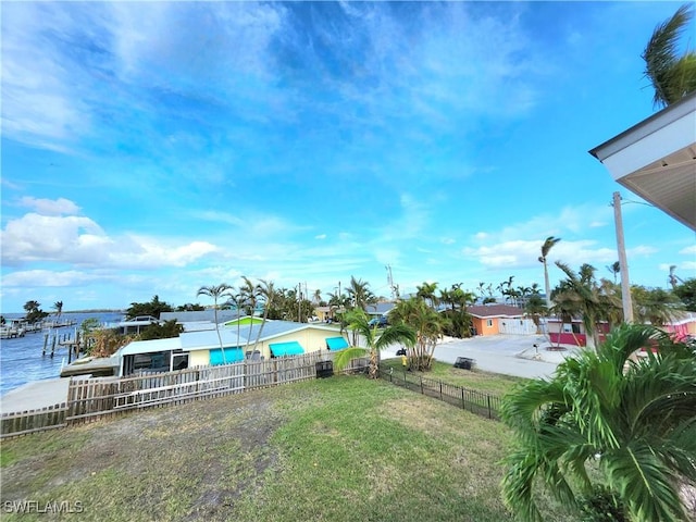 view of yard featuring a water view and a boat dock