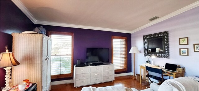 living room with hardwood / wood-style flooring, ornamental molding, and plenty of natural light