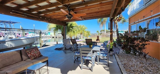 view of patio with a water view, outdoor lounge area, and ceiling fan