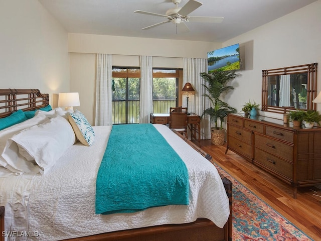 bedroom featuring hardwood / wood-style flooring, access to outside, and ceiling fan