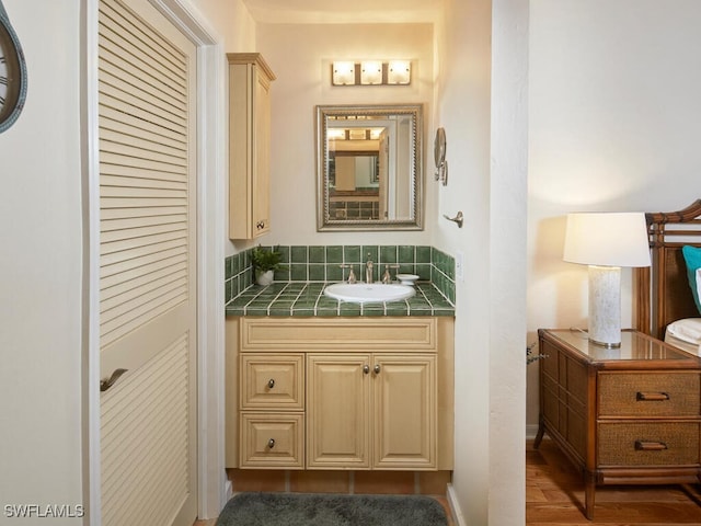4021 Whiskey Pointe Ln Unit 202, Bonita Springs, FL 34134 - bathroom featuring vanity and wood finished floors