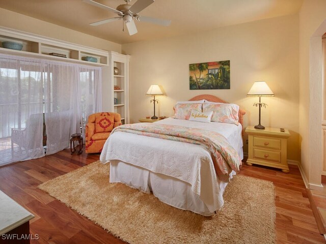 4021 Whiskey Pointe Ln Unit 202, Bonita Springs, FL 34134 - bedroom with access to outside, wood finished floors, and a ceiling fan