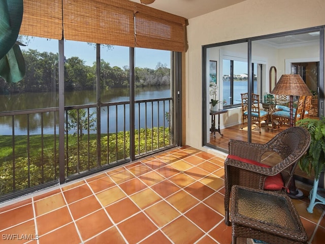 4021 Whiskey Pointe Ln Unit 202, Bonita Springs, FL 34134 - sunroom with a water view, healthy amount of natural light, and tile patterned flooring