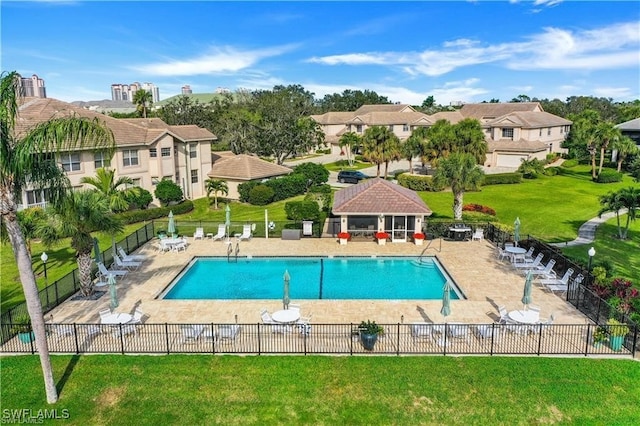 view of pool featuring a patio and a lawn