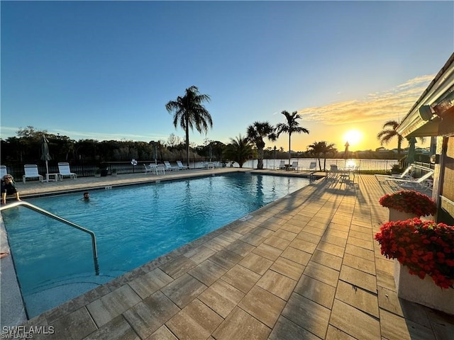 4021 Whiskey Pointe Ln Unit 202, Bonita Springs, FL 34134 - pool at dusk featuring a community pool and a patio area