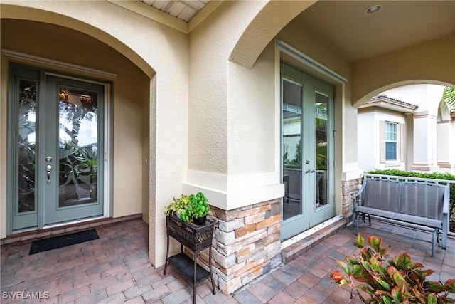 doorway to property with french doors and stucco siding
