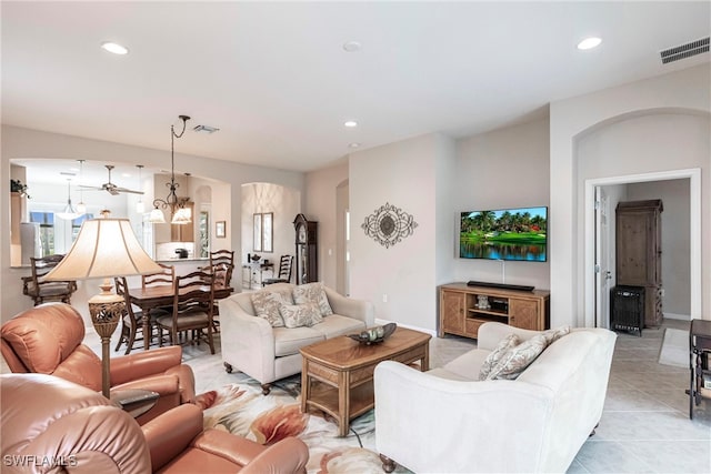 tiled living room with an inviting chandelier