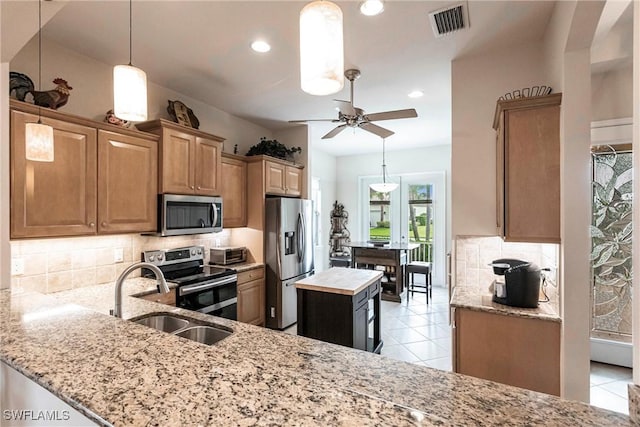 kitchen with decorative backsplash, light stone countertops, stainless steel appliances, and visible vents