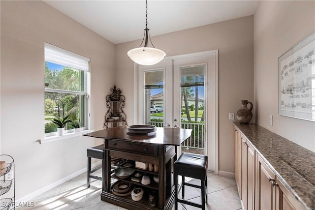 dining area featuring baseboards and light tile patterned floors