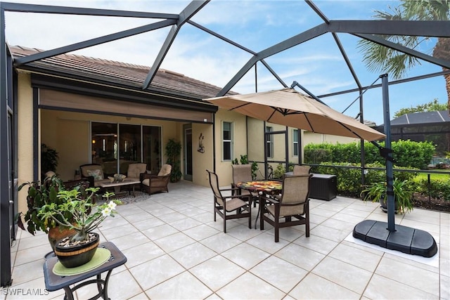 view of patio with outdoor dining area, glass enclosure, and an outdoor hangout area