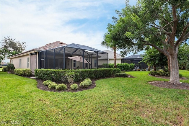 view of yard with glass enclosure