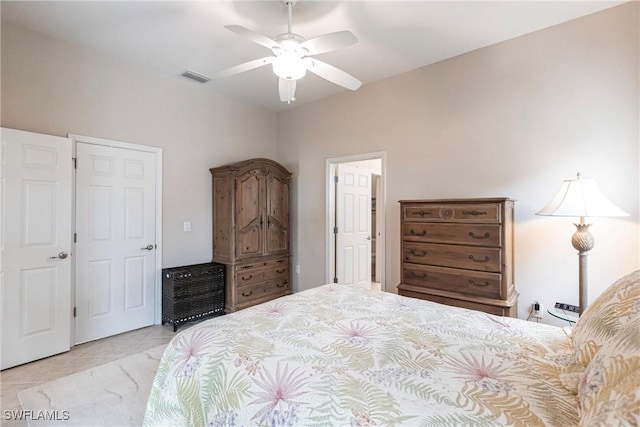 bedroom with tile patterned flooring, a ceiling fan, and visible vents