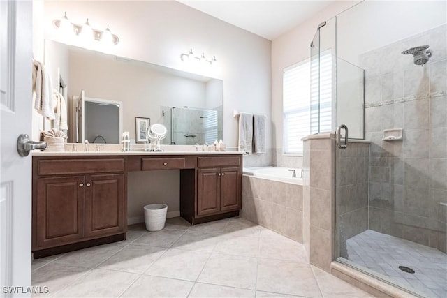 bathroom with double vanity, a garden tub, a stall shower, a sink, and tile patterned floors