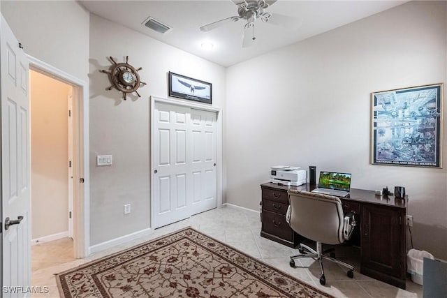 office space featuring baseboards, ceiling fan, light tile patterned flooring, and visible vents