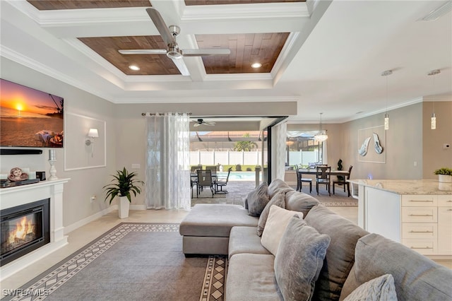 living room with ornamental molding, light tile patterned floors, coffered ceiling, and ceiling fan