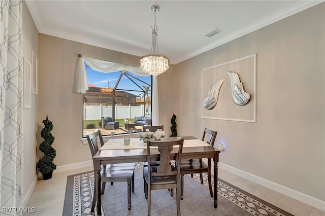 dining room with crown molding, a notable chandelier, and light tile patterned floors